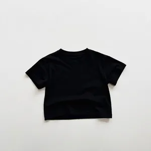 Detailed view of kids minimalist black cotton t-shirt showing basic crew neck design