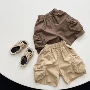 Detailed flat lay of children's tie-dye cargo shorts with elastic waist and side pockets