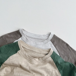 Close-up detail showing the slub cotton fabric texture of kids raglan sleeve t-shirts
