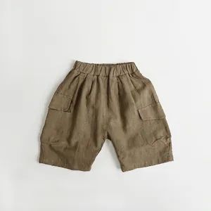 Detail view of coffee-brown cotton linen kids cargo shorts with elastic waist and pockets