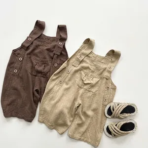 Detailed flat lay of toddler cotton overalls with front pocket and button straps