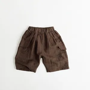 Detailed view of brown cotton-linen kids cargo shorts with elastic waist and side pockets