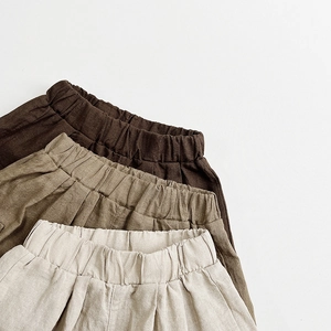 Detail of kids cotton linen cargo shorts showing elastic waist and natural fabric texture