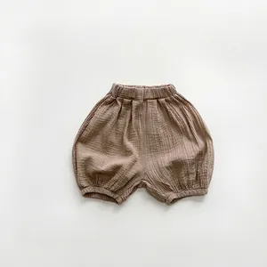 Close-up of soft double-layer cotton gauze texture on dark apricot baby bloomers