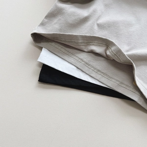 Detail of double-needle stitching on gray white and black cotton t-shirt hems