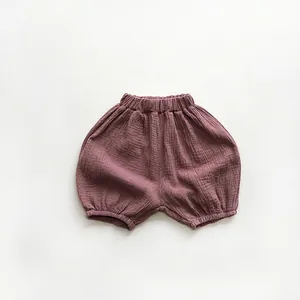 Detail of baby cotton gauze bloomers in dusty purple with breathable crinkled texture