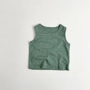 Close-up of deep green slub cotton kids tank top showing textured breathable fabric