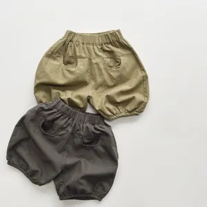 Detail view of olive green and charcoal grey cotton blend bloomers for kids with elastic waist