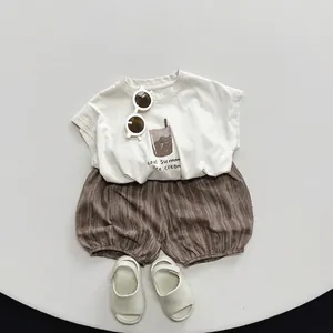 Toddler summer tie-dye outfit with cream graphic t-shirt and brown ripple shorts