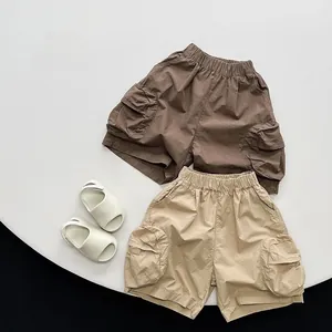 Flat lay of cotton cargo shorts for toddlers with large pockets and elastic waistbands