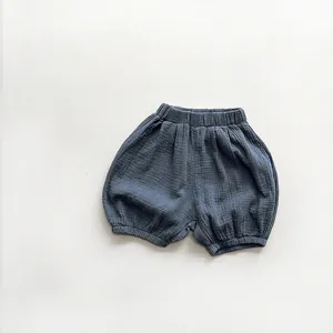Close-up of soft grey-blue crinkle gauze fabric texture on breathable toddler bloomers