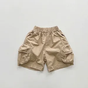 Flat lay of khaki cotton cargo shorts featuring drawstring waist and side utility pockets