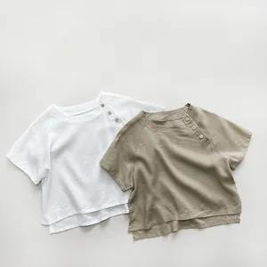 Detailed macro view of linen-cotton fabric texture and wooden buttons on kids' shirts