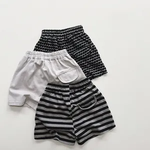 Flat lay of cotton kids summer shorts featuring polka dots, stripes and solid colors