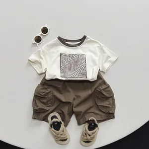 Kids summer cotton outfit set with beige t-shirt and brown cargo shorts in minimalist style