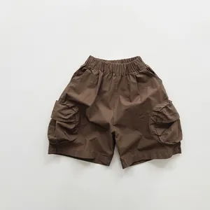 Brown cotton cargo shorts for kids featuring elastic waist and large side flap pockets