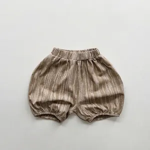 Detail view of khaki children tie-dye bloomers with elastic waist and vertical texture
