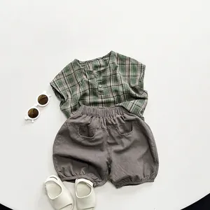Summer kids set with green plaid sleeveless shirt and grey cotton shorts in Korean style