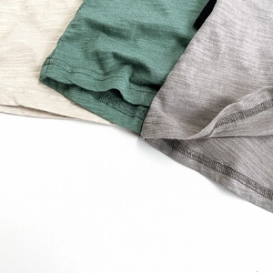 Detail of slub cotton fabric showing double-needle stitching and breathable texture