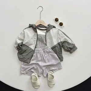 Kids summer outfit set with grey hooded jacket, printed T-shirt and light purple shorts