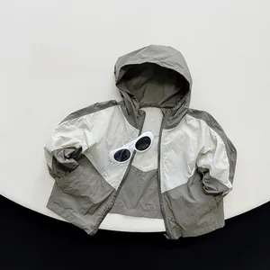 Close-up of color-block kids hooded sun-protection jacket in light green and cream