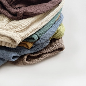 Breathable cotton muslin bloomers for toddlers in various earthy colors and elastic waist