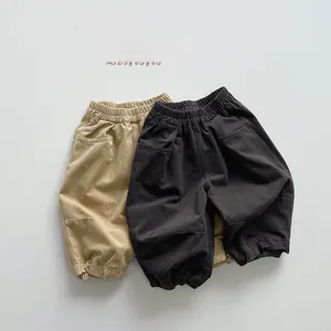 Detail of khaki and charcoal grey kids joggers with elastic waist and stitched knee panels