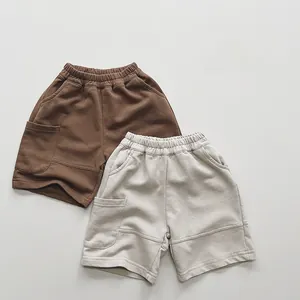 Close-up of kids cargo knit shorts in brown and beige with large side pockets