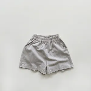 Detailed texture of khaki cotton kids shorts with elastic high waist and side pockets