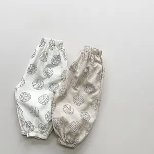 Detail view of cotton kids anti-mosquito pants with elastic cuffs and leaf prints