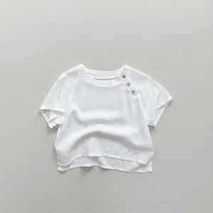Detail of white cotton linen kids t-shirt showing shoulder buttons and fabric texture