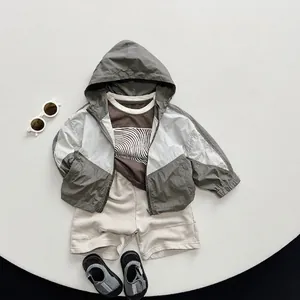 Kids casual summer outfit with hooded jacket, brown t-shirt, beige shorts and sandals