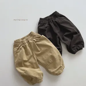 Detail showing elastic waist and ribbed cuffs on khaki and brown cotton trousers