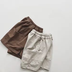 Close-up of children's cotton knit shorts with elastic waist and large square patch pockets