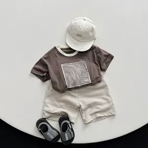 Kids minimalist cotton summer set with dark brown printed T-shirt and beige shorts