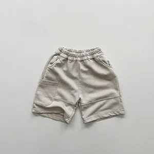 Detailed close-up of kids beige knit shorts with elastic waistband and utility pocket