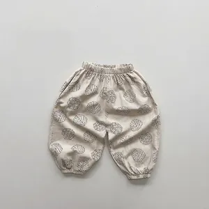 Detail of baby cotton linen joggers showing elastic waistband and grey leaf print pattern