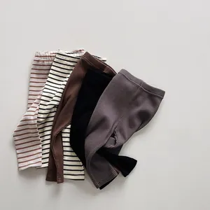 Detailed stack of five pairs of ribbed cotton leggings for kids in striped and solid colors
