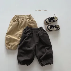 Detailed close-up of khaki and coffee casual cotton pants showing elastic waist and pockets