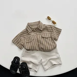 Detailed flat lay of children striped short sleeve shirt and beige cotton shorts set