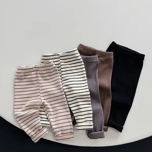 Close-up of ribbed cotton leggings for children in striped and solid neutral colors