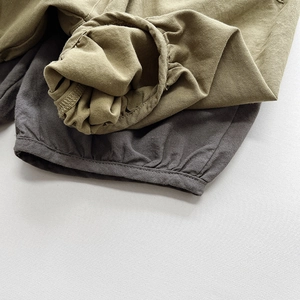 Close-up of elastic hem and cotton linen texture on kids loose bloomer shorts
