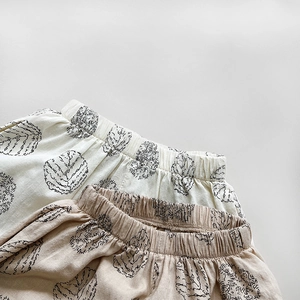 Close-up of printed cotton summer mosquito pants with breathable plant pattern for kids