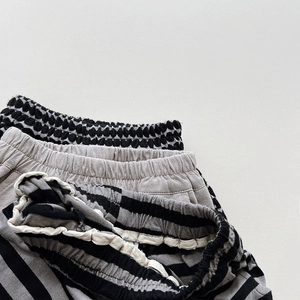 Detail showing elastic waistbands of three cotton knit shorts with stripe and dot patterns