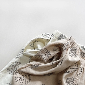 Detail of breathable cotton fabric texture and abstract print on kids elastic waist pants