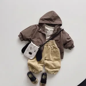 Kid's forest style zip hooded jacket set with khaki trousers and puppy bag flat lay