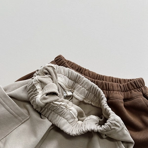 Detailed macro view of the soft cotton knit texture and elastic waistband of baby shorts