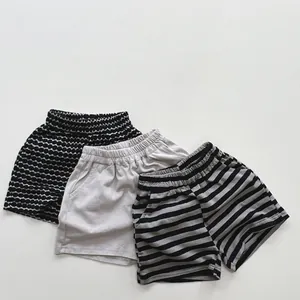 Three pairs of kids cotton shorts with polka dots, solid grey, and striped patterns