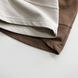Detailed macro view of neat double-needle stitching and high-quality knit fabric hem