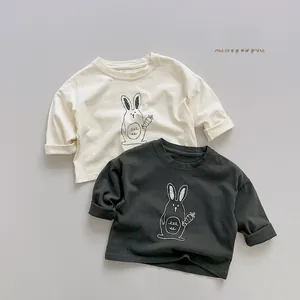 Detail of soft cotton kids long sleeve shirts with cute rabbit graphics in cream and charcoal